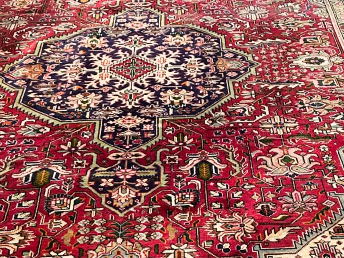 Freshly cleaned red Heriz oriental rug with a navy medallion, the colors bright down to the base of the pile